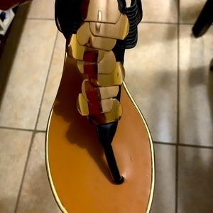 Black leather sandals with gold accent and heel